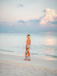 Model walking on the beach in the Maldives at sunrise