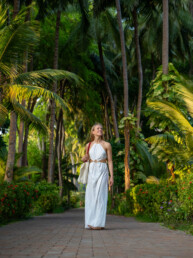 Model walking among palm trees in Maldives