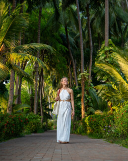 Model walking among palm trees in Maldives