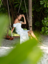 Model on swing by the beach in the Maldives